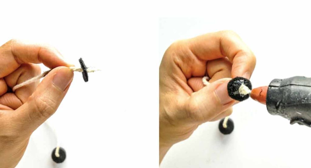 Shows hands applying glue to black felt circle and thread for making magnetic fishing rod for kids