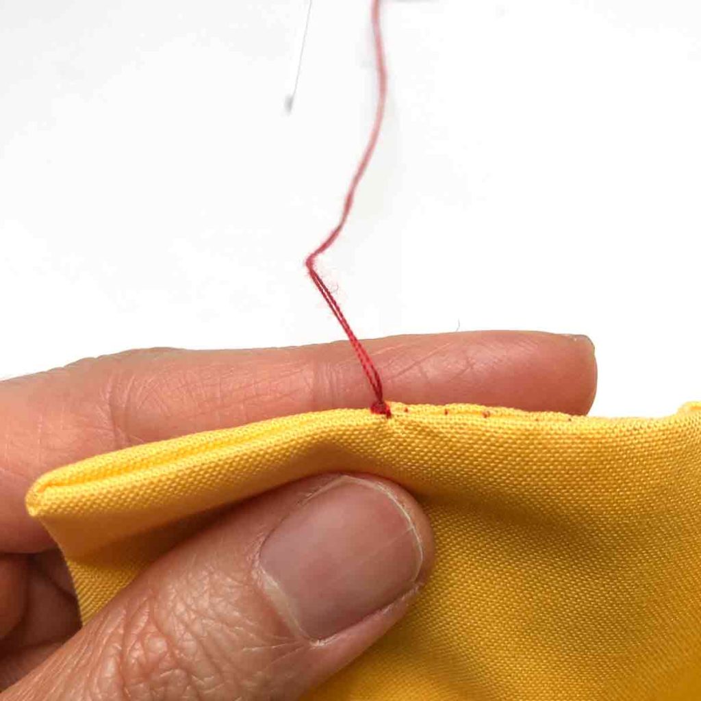 Shows knot at the end of invisible ladder stitch.