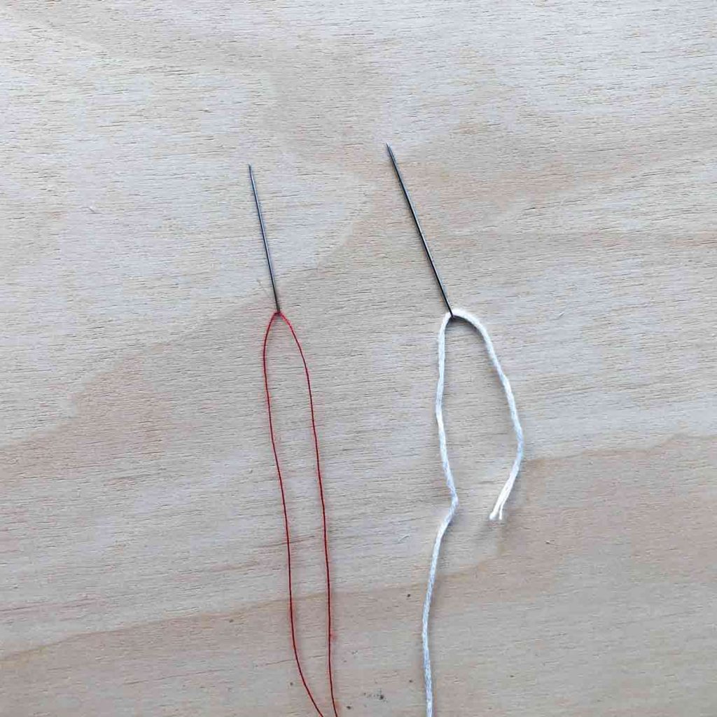 Left side shows a double threaded needle. Right side shows a embroidery floss threaded needle. How do you do inside out stitch tutorial.