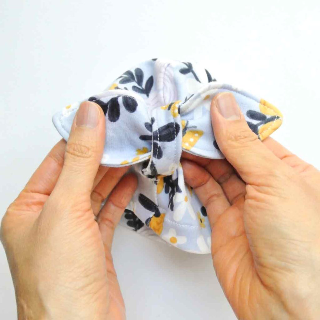 Adjusting knot on front of DIY baby bow hat