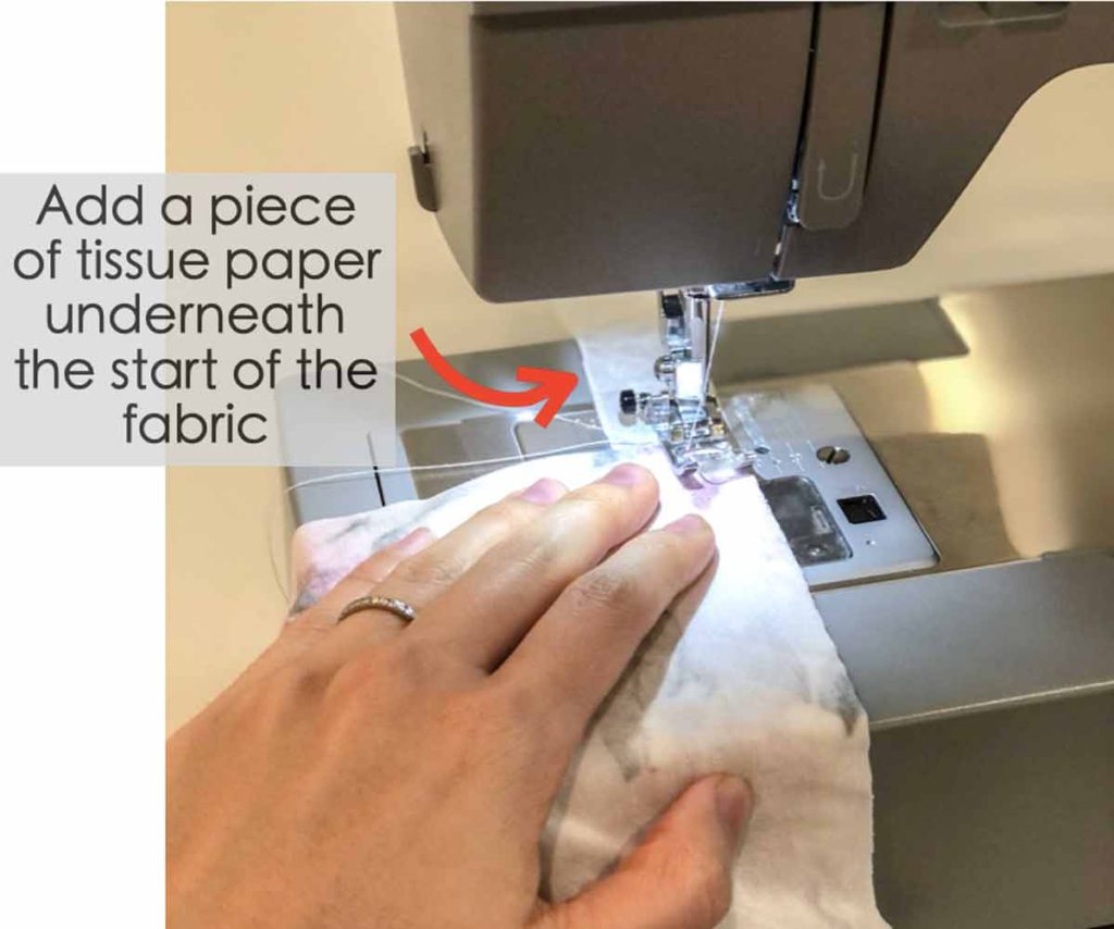 How to Sew Knit Fabric, adding tissue paper to start of fabric