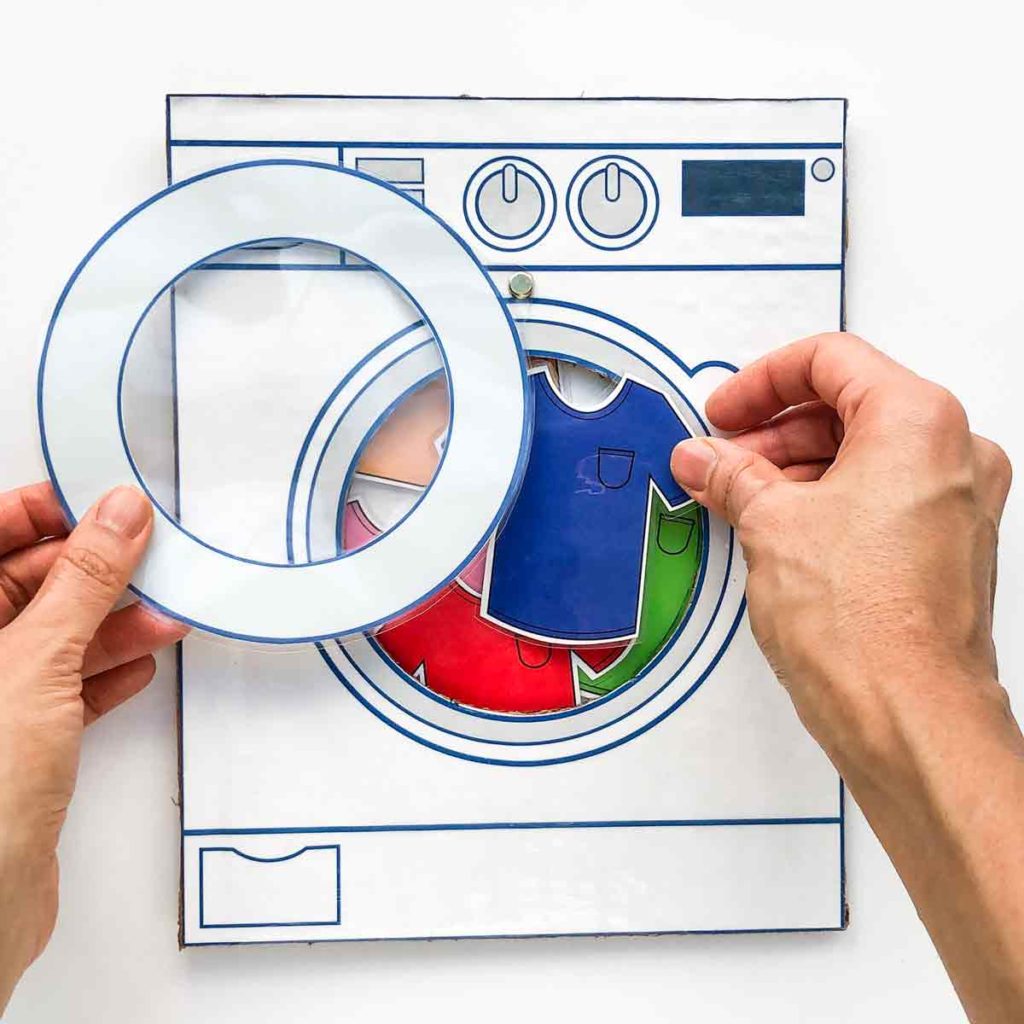 Finished washing machine with colored shirts inside. Color sorting and matching activity for toddlers and preschoolers. 