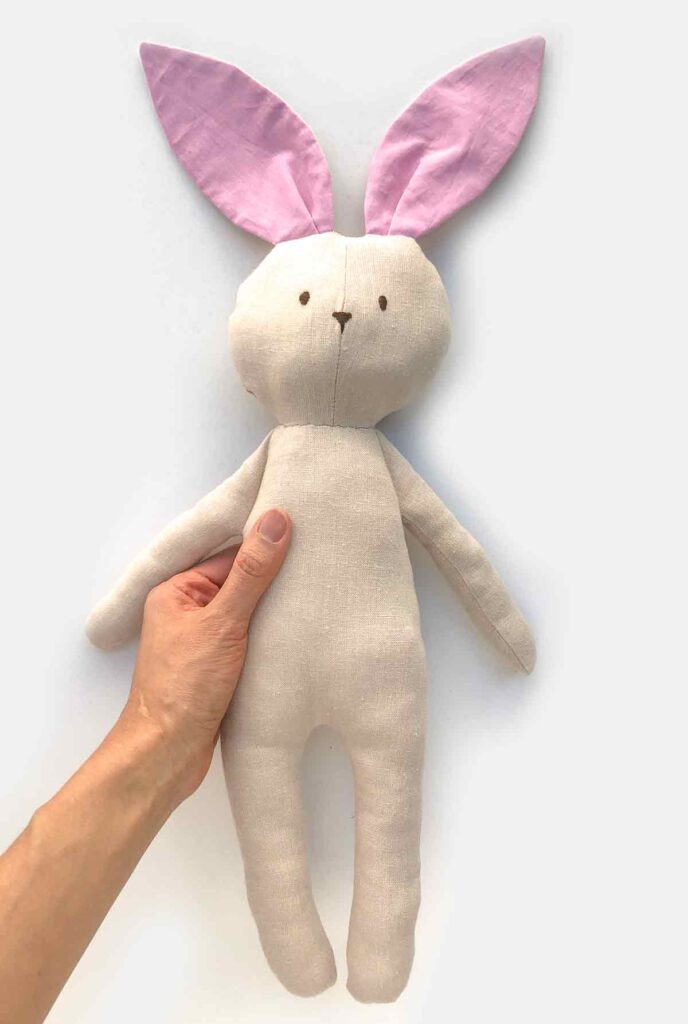 Hand holding finished bunny plush