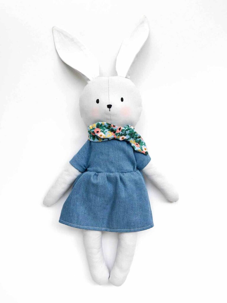 Finished bunny plush in denim dress and floral scarf