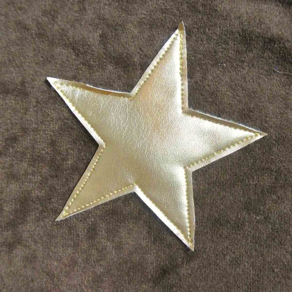 gold sheriff star sewn onto vest with straight stitch