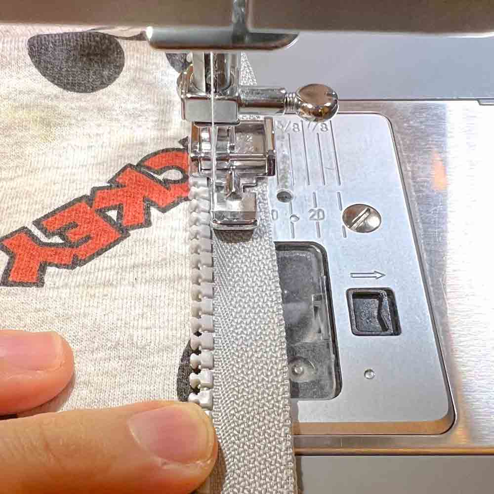stitching zipper down to jacket