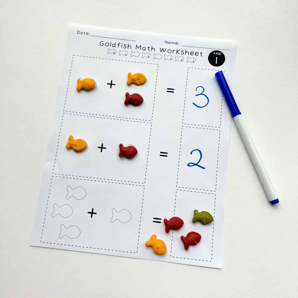 addition for kindergarten. worksheet with goldfish placed on outline and number answers written.