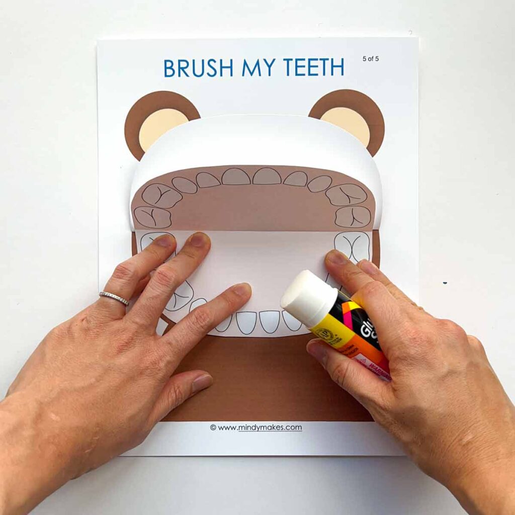 Gluing oral cavity into inside of Mr Bear's mouth. Dental health activities for preschoolers