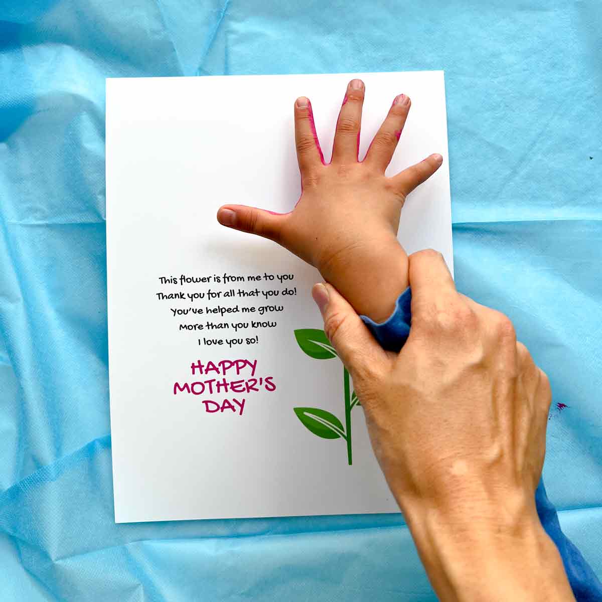 helping child stamp their handprint
