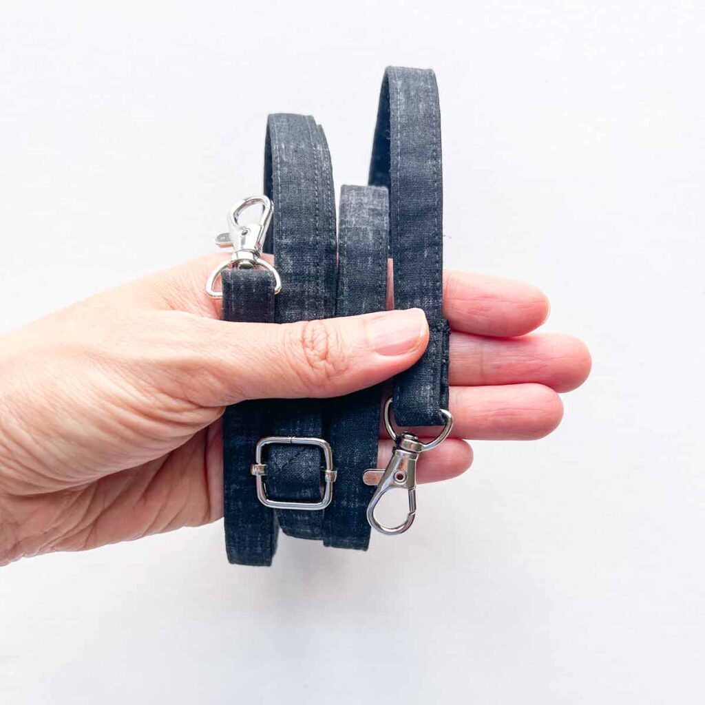 Hand holding a finished adjustable bag strap