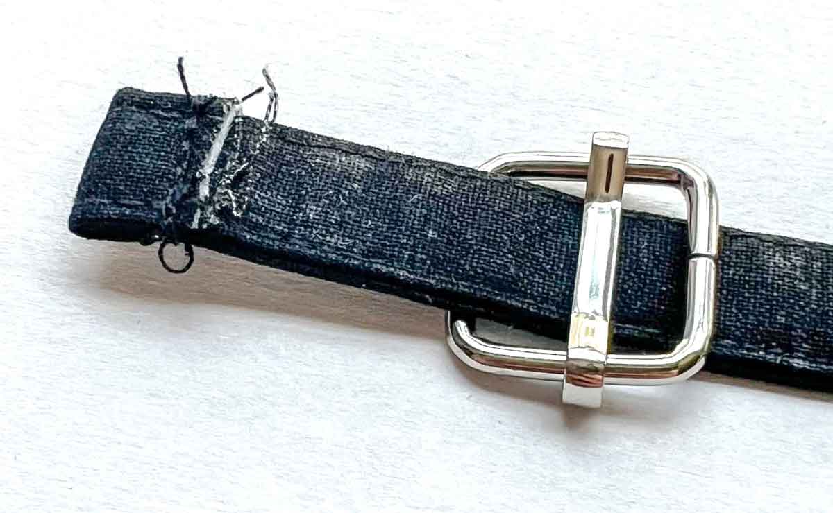 sliding end of fabric strap into triglide slider.