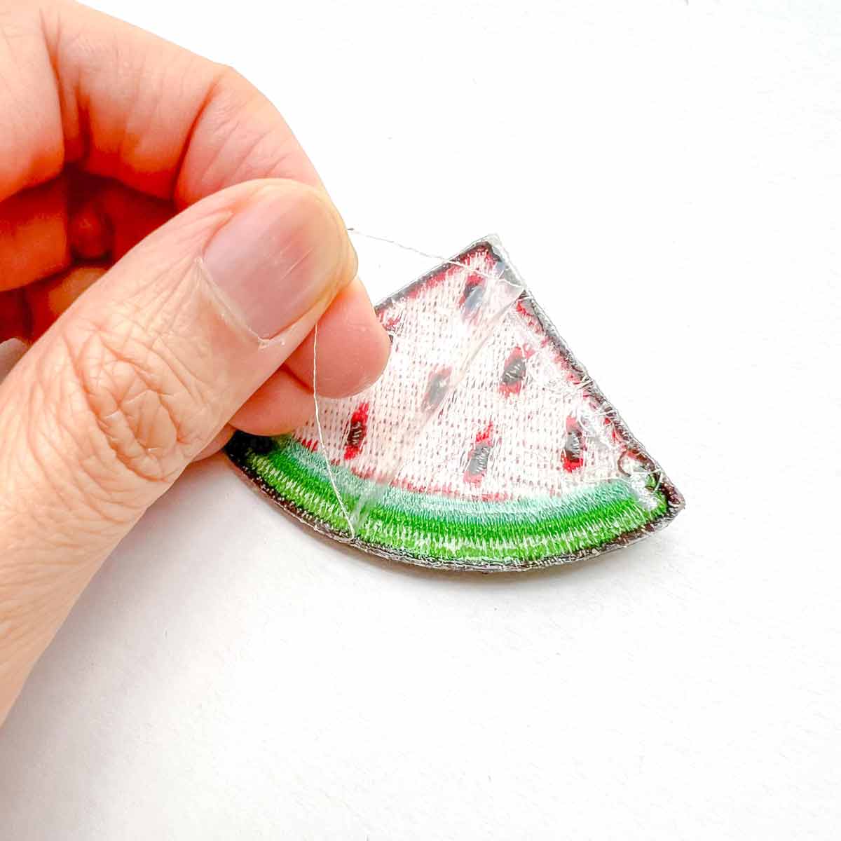removing clear acetate backing on patch. How to Sew on a Patch