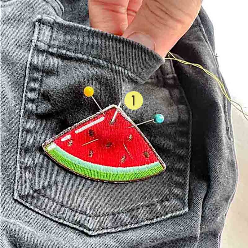 Bringing needle from front to back of garment to patch. How to Sew a Patch on by hand.