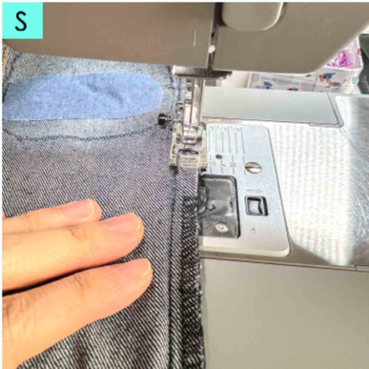 sewing up side seam of jeans after repair is done.