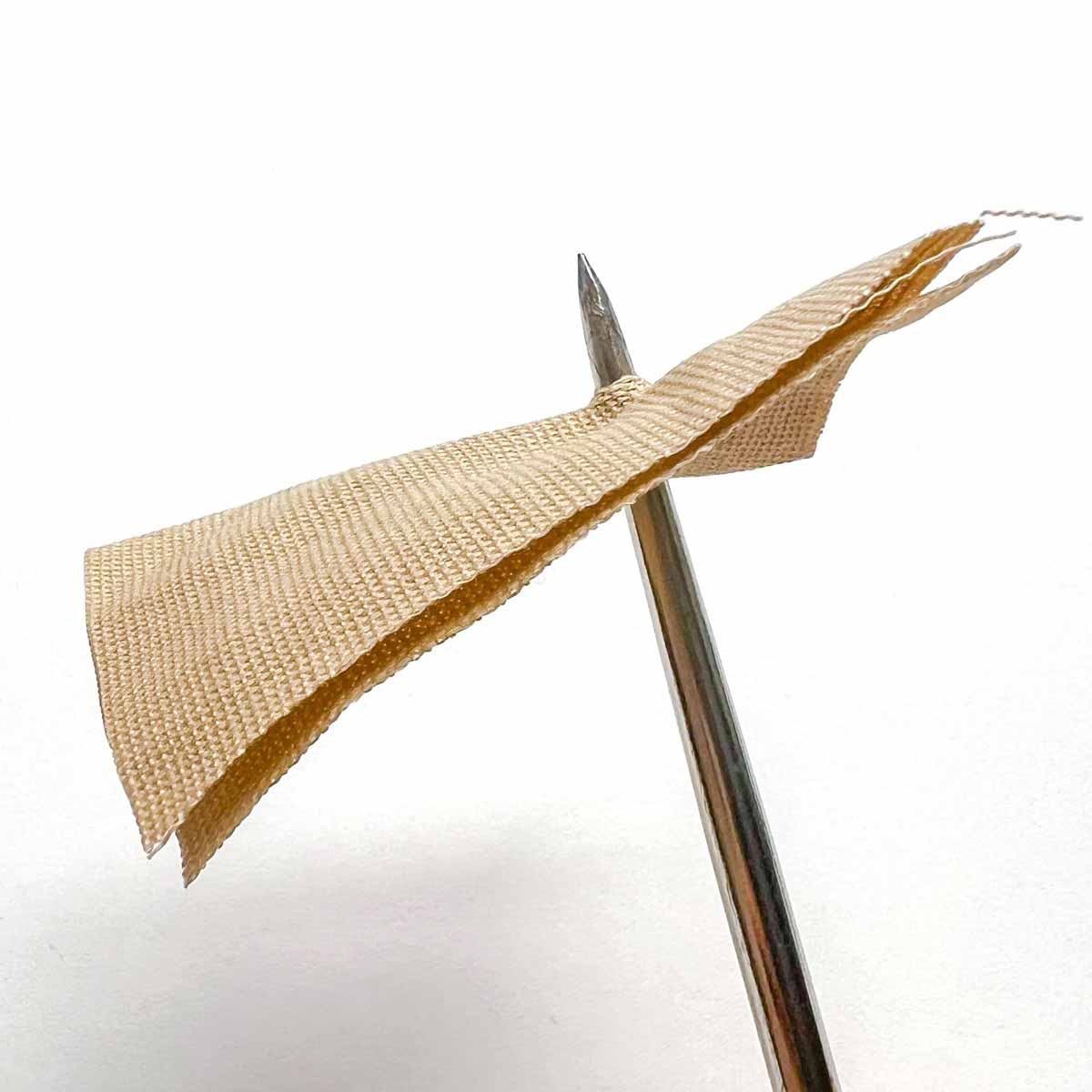 Step-by-step snap fastener installation tutorial - poking hole through fabric with awl