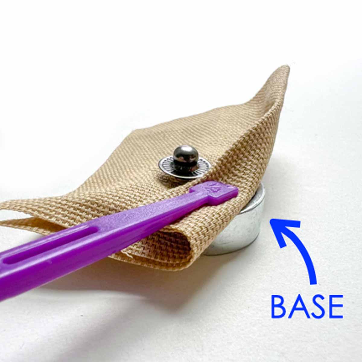 putting base under fabric before hammering. Step-by-step snap fastener installation tutorial