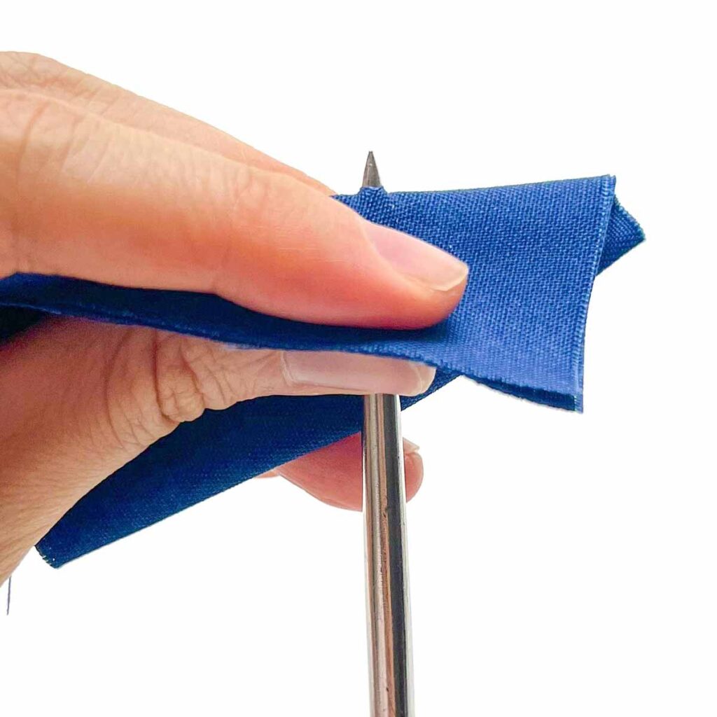 Step-by-step snap fastener installation tutorial - poking hole with awl
