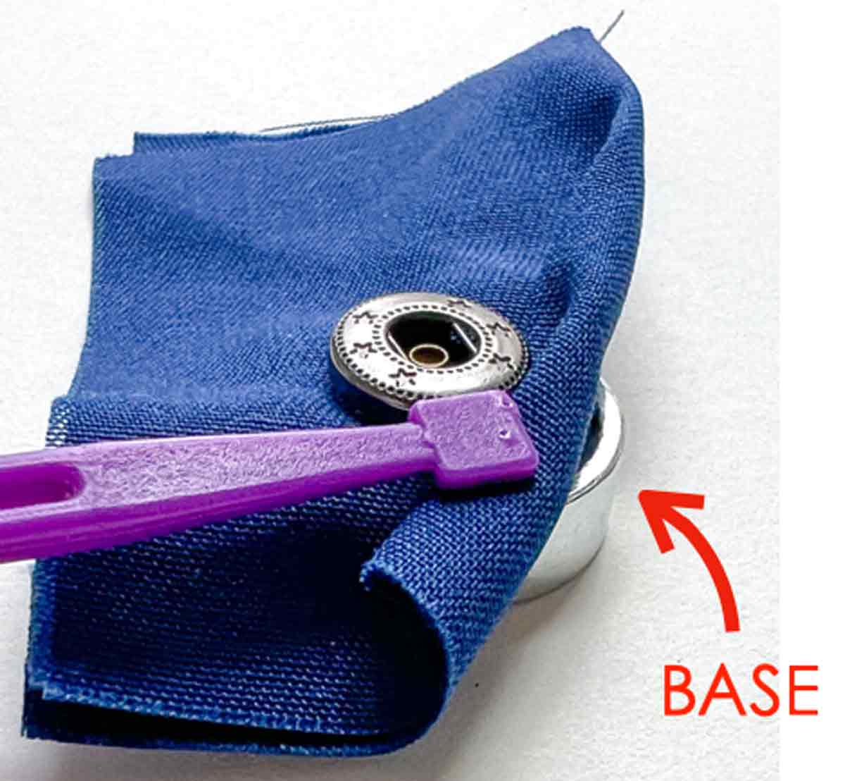 Step-by-step snap fastener installation tutorial - inserting base under fabric