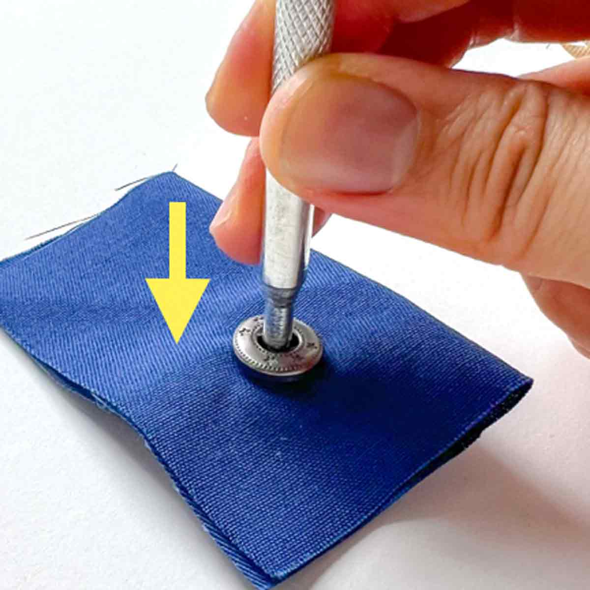 Step-by-step snap fastener installation tutorial - placing pointed install tool over snap stud