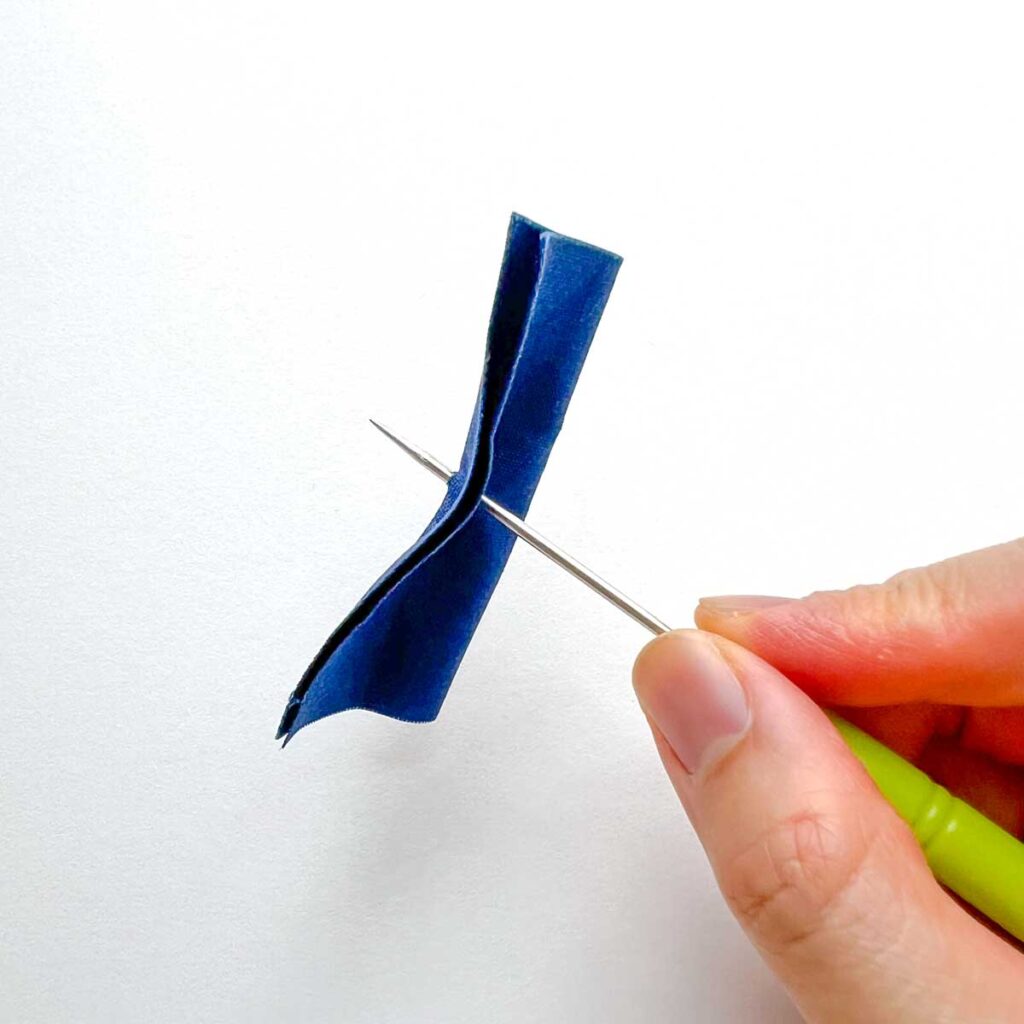 How to apply snaps to fabric using a snap press - poking hole through fabric with awl. 