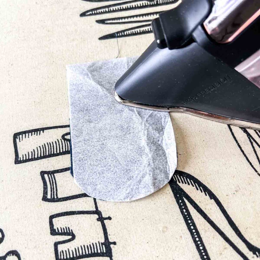 applying fusible interfacing to wrong side of flap piece for cross body cell phone bag