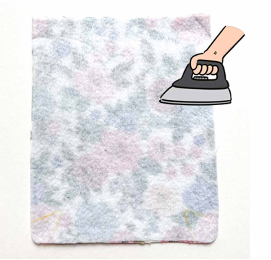 ironing on fusible fleece to pocket. crossbody cellphone bag tutorial
