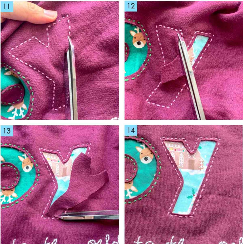 Carefully cutting away sweatshirt fabric around stitched reverse appliqué