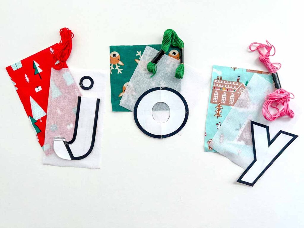 contrasting fabric, embroidery floss, interfacing, and design templates for reverse applique