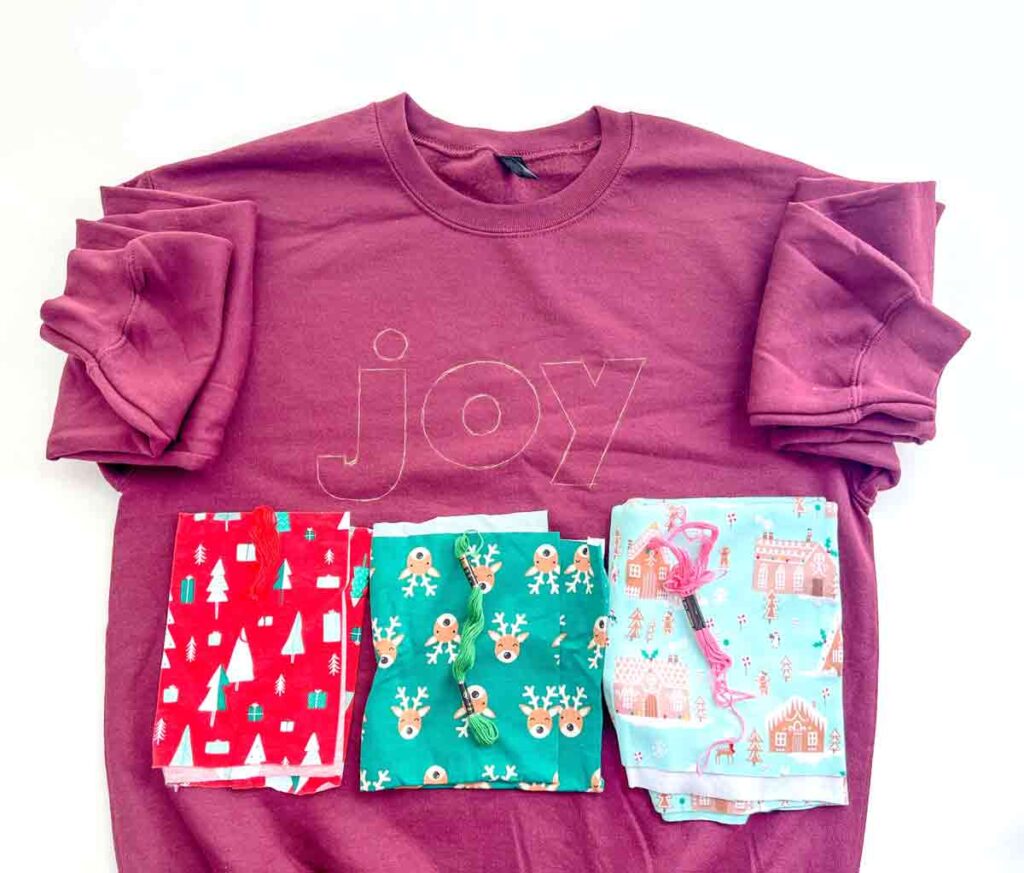 letter template traced onto sweatshirt with contrasting fabrics below and embroidery floss