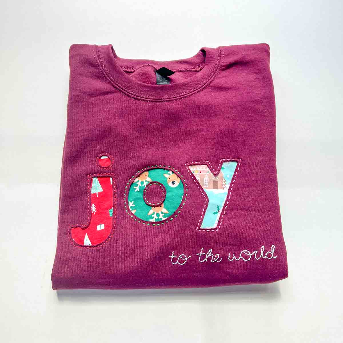 Finished DIY reverse appliqué sweatshirt with a colorful fabric design