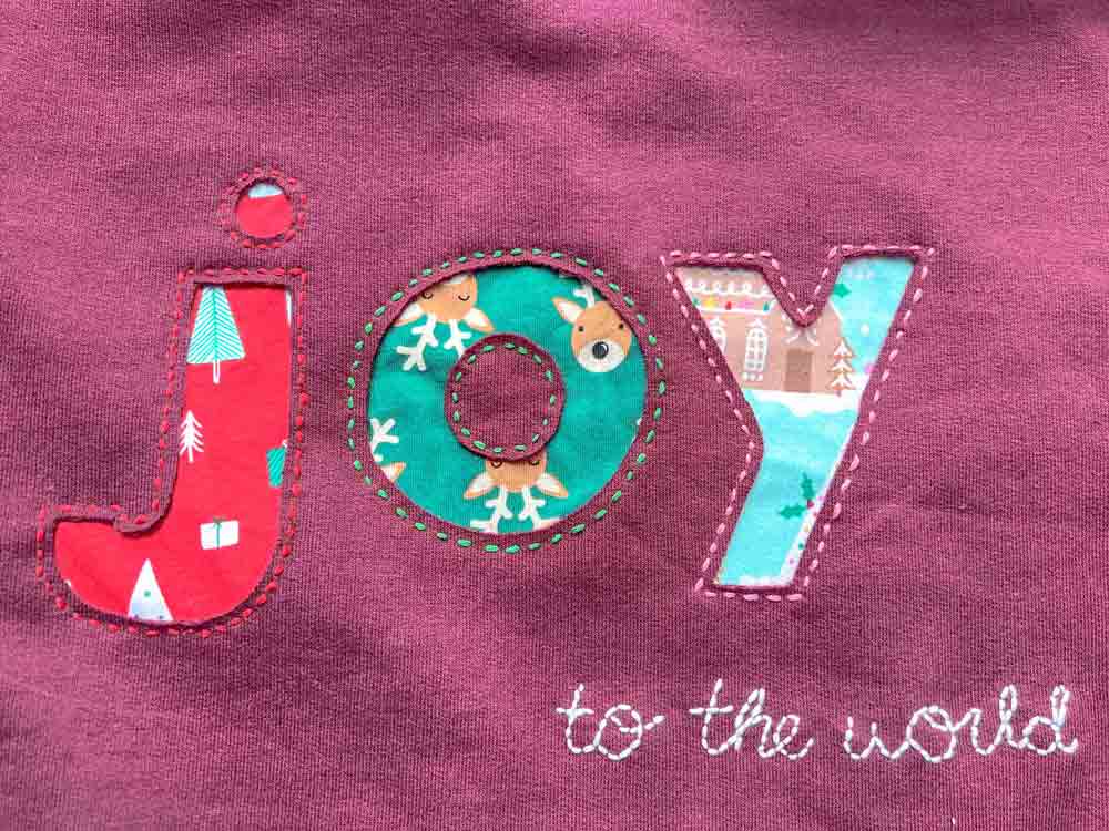 Finished DIY reverse appliqué sweatshirt with a colorful fabric design